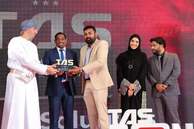 Award ceremony with team receiving TAS recognition on stage